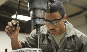 Worker at a manufacturing company following a process streamlined with ERP