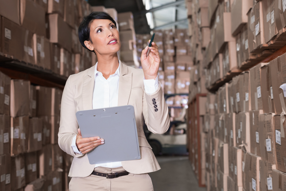 Woman checking inventory with clickboard